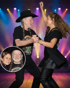 “HE DIDN’T SING THIS ONE — HE LIVED IT.” At 92, Willie Nelson didn’t need a microphone to move a crowd. He’d already done that for seven decades. But that night, under the soft glow of his own festival lights, something different happened. The band was playing low, the air thick with that kind of stillness that only comes before magic. Then Willie did something no one expected — he set his guitar down. Slowly, he reached for Annie’s hand and pulled her close. They didn’t care about rhythm. They didn’t care about the cameras. They just danced — the way people do when they’ve already said everything that matters. And when the lights turned gold, he leaned in and whispered something only she could hear. No one knows what he said. But everyone felt it. 571149815 122211499964050701 1862907427783360984 n