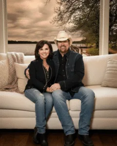 It’s a small sound — soft, steady, almost like a heartbeat. But after all these years, it still makes her smile. They’ve lived through the noise and the spotlight, but this is the rhythm that’s lasted: a worn cowboy hat on the couch, two coffee cups cooling between stories that never really end. Toby doesn’t talk much about love — he never had to. He’s always shown it in the quiet ways: a glance, a laugh, a song written long ago that somehow still fits today. And when “You Shouldn’t Kiss Me Like This” comes on, she leans her head just a little closer, and he grins, because after all this time, it still feels like the first dance. Featured image