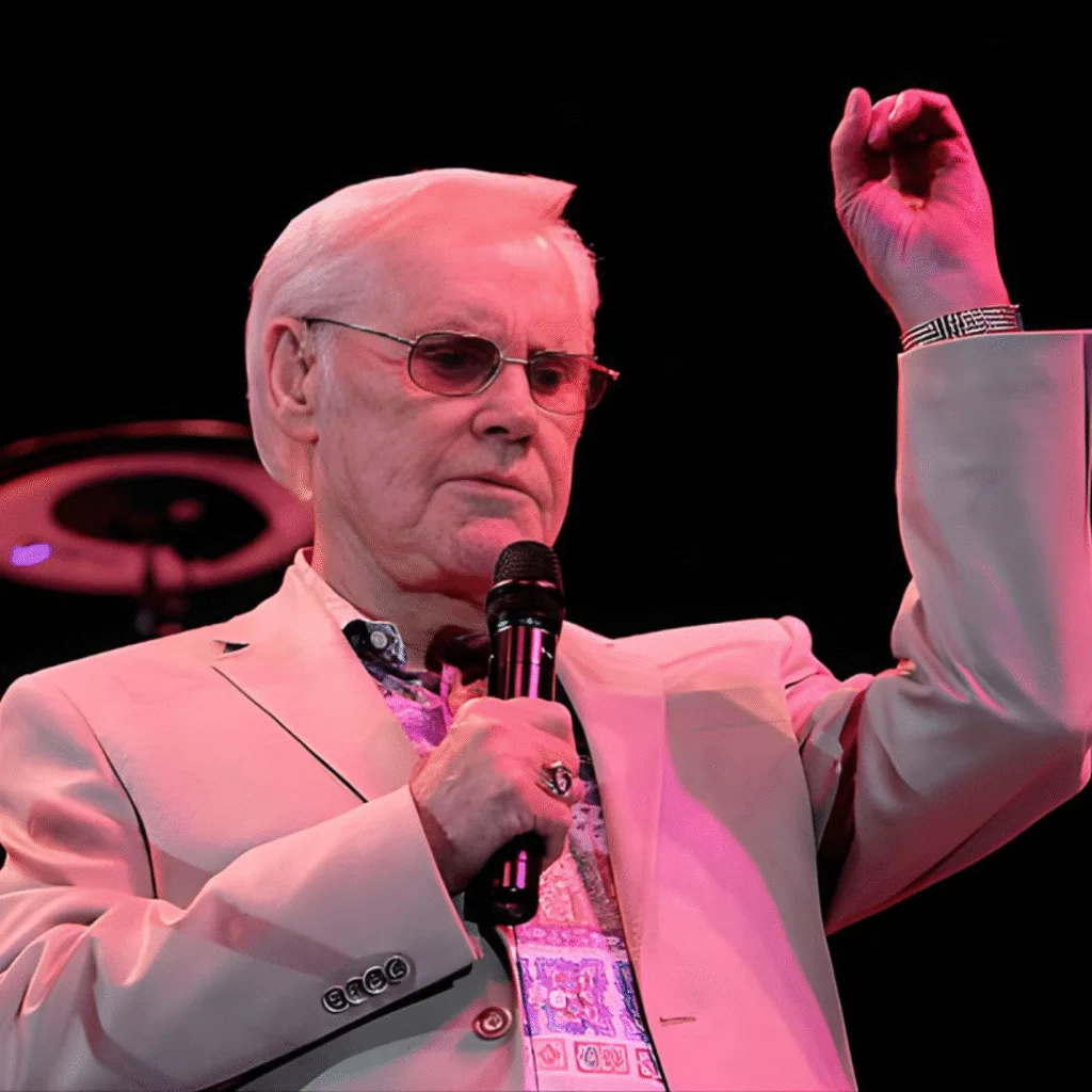 “HE SANG FOR PEOPLE WHO LOVED TOO HARD AND PAID FOR IT.” George Jones never tried to sound strong. He sounded honest. When he sang “He Stopped Loving Her Today,” it wasn’t drama — it was surrender. The kind that comes after years of fighting yourself. After promises broken quietly. After loving someone more than you knew how to survive. George didn’t sing about happy endings. He sang about truth showing up late. About regret that stays. About love that doesn’t leave, even when people do. His voice cracked because life cracked first. And somehow, that made people feel less alone.