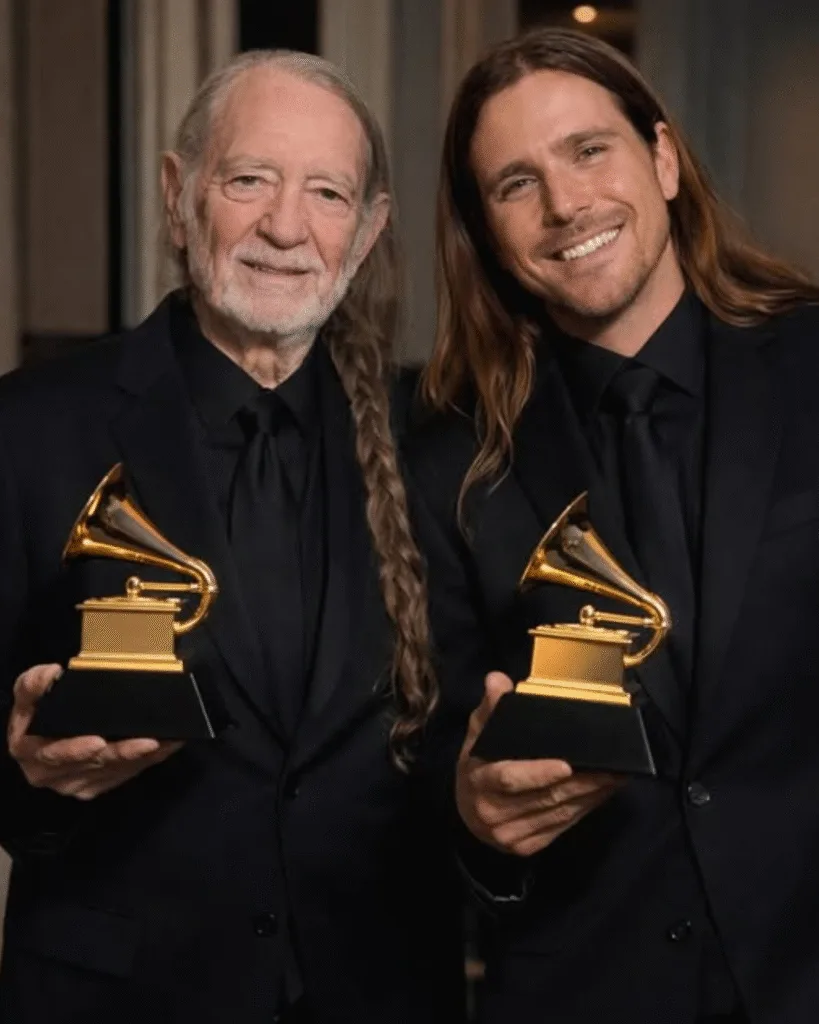 THE 2026 GRAMMY NOD THAT HIT DIFFERENT — FATHER AND SON. Congratulations to Willie Nelson and his son Lukas on their 2026 Grammy nominations for Best Traditional Country Album. It’s the kind of news that makes you pause. Not because of the trophy. But because of the quiet look behind it. Willie doesn’t rush anything. He never has. Lukas stands beside him, steady, listening more than he speaks. Same room. Same songs. Different seasons of the same life. You can almost see it—the soft stage lights, a small nod, the way a father lets a son lead without stepping away. This isn’t about winning. It’s about sharing the road, mile by mile, and knowing the music will keep going.