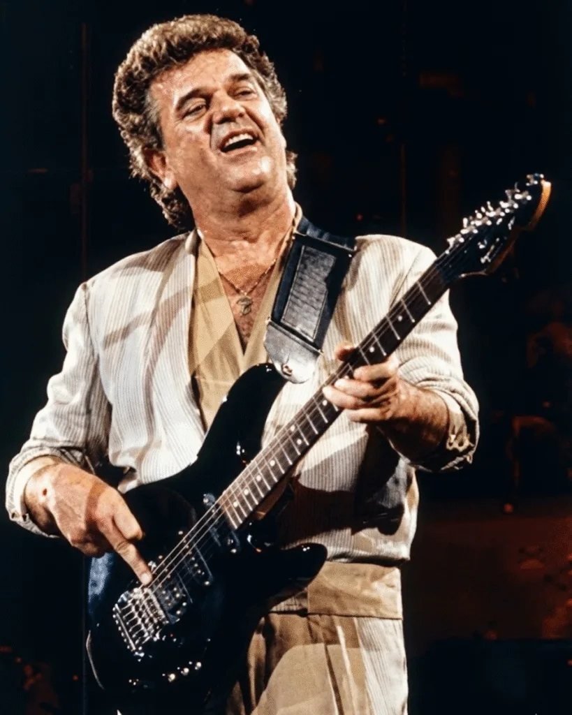 HE DIDN’T JUST SING — HE LET MEN FEEL SEEN.” ❤️ Conway Twitty had this quiet way of telling the truth — the kind most men keep tucked inside. He didn’t shout his feelings or dress them up. He just let them breathe through that warm, slow, velvet voice. When he sang about love, it wasn’t perfect flowers-and-candles romance. It was the real kind — the kind that gets tired, jealous, scared, hopeful, and still shows up anyway. In songs like Hello Darlin’, you could hear a man trying to be strong while his heart was falling apart. And in I’d Love to Lay You Down, he reminded couples that tenderness doesn’t disappear with time — it just gets quieter, deeper. What made Conway special wasn’t the passion in his songs, but the respect. He could sing about desire without ever crossing the line. He made women feel understood, and he made men feel less alone. Decades later, that honesty still hits like truth whispered in the dark.