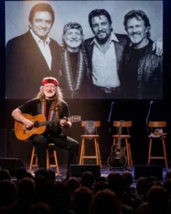 🔥 At 93, Willie Nelson sang to three dead men — and the recording later proved he might not have been alone. The Hollywood Bowl lights dimmed as Willie walked slowly into a single spotlight, Trigger hanging against him like a lifetime of memories. Three empty chairs waited beside him. Waylon Jennings’ scarf. Johnny Cash’s black guitar. Kris Kristofferson’s hat. No speeches. Just a quiet nod — and then he began: “I was a highwayman…” His voice trembled but held steady. The crowd fell silent. Then something strange happened. Low harmonies seemed to rise from the microphones placed before the empty chairs, blending into Willie’s voice as if the song remembered who used to sing it together. Later, when engineers replayed the recording, they heard faint layers — tones that didn’t belong to just one man. No one called it supernatural. But for one brief moment… Willie Nelson didn’t sound alone.
