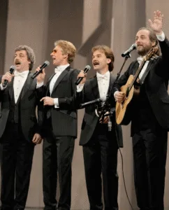 “THE FINAL ‘THANK YOU’ THAT MADE THOUSANDS CRY IN THE SAME MINUTE.” That night in Virginia didn’t feel like a concert. It felt like a held breath. Thirty-eight years of harmony sat quietly in the room as The Statler Brothers walked out one last time—slower, steadier, eyes shining with the kind of knowing that needs no speech. Before a single note, you could already see it: hands to faces, heads bowed, people bracing for something they weren’t ready to lose. Some had been there since Flowers on the Wall. Others grew up on Elizabeth. But when the opening line of Thank You World drifted out, time softened. The crowd didn’t just listen—they stood, almost without thinking, as if standing was a promise: we’ll remember. There were no fireworks. No big goodbye speech. Just four voices offering gratitude instead of grief. And in that shared minute—when thousands wiped their eyes at once—it wasn’t only their farewell. It was the quiet closing of an era that knew how to say goodbye with grace. When a song becomes a goodbye, are we mourning the artists on stage — or the part of our own lives that’s quietly ending with them?